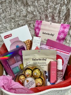 a basket filled with lots of different types of items and some pink tissue on the floor