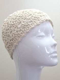 This lacy crochet beanie in cream will add a stylish touch to any outfit. Hand crafted with high quality 100% cotton yarn, it is perfect for any occasion, including weddings. If you would prefer this crochet skull cap in a different size or colour, please message me and I will be happy to help.  Materials: 100% cotton yarn Measurements: Diameter approx. 56cm (will stretch a little with wear) Height - Crown to base 18cm Care Instructions: Handwash or machine wash on a wool cycle at 30oC and dry f Cream Knitted Cotton Hat, Cream Crochet Cap For Spring, White Handmade Crochet Hat Fitted, Cream Yarn Beanie, White Hand-knitted Crochet Hat In Cotton Yarn, Hand Knitted One Size Cream Crochet Hat, One Size Cream Crochet Hat Hand Knitted, Cream Hand Knitted Crochet Hat One Size, Fitted White Hand Knitted Crochet Hat