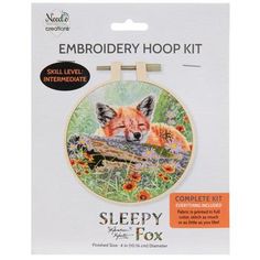 an embroidery kit with a fox on it's back and the words sleepy fox written in