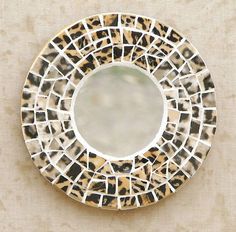 a mirror that is sitting on top of a wall next to a tile pattern design