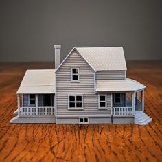 a model house sitting on top of a wooden table