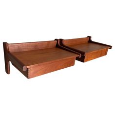 two wooden trays sitting on top of each other