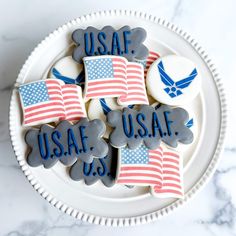 decorated cookies on a plate with the words usa, usaf, u s air force