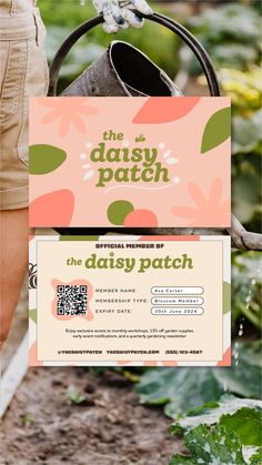 the daisy patch coupon is being held up by someone's hand and holding a watering