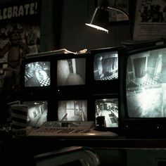 several televisions sitting on top of a table