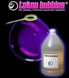 a bottle of liquid next to a purple object