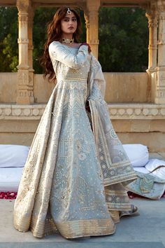 a woman in a white and gold gown