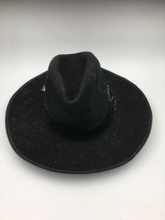 This men's Vintage Hat is a true masterpiece of Bavarian design. The alpine-inspired wide brim, coupled with the black felt material, gives this hat a timeless look that is perfect for any occasion. Circa 1880, this piece is not only stylish but also full of history and character.  Men's hunting hat circa late 1880.  This hunting hat was worn in the alpine areas of the Austro-Hungarian empire. Black wool felted hat with a wide brim edged in leather, deep crease in the crown, and trimmed black ve Black Short Brim Felt Hat For Ranch, Wide Brim Black Hat For Ranch, Black Wide Brim Hat For Ranch, Black Brimmed Fedora For Ranch, Vintage Black Top Hat For Western-themed Events, Black Fedora Hat For Ranch, Black High Crown Top Hat For Western-themed Events, Black Fedora For Ranch, Western Style Black Felt Hat For Outdoor