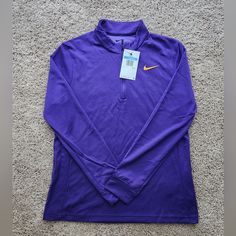 This Nike Dri-Fit Uv Victory 1/2 Zip Pullover Is Perfect For Women Who Enjoy Outdoor Sports And Activities. The Long Sleeve Top Comes In A Beautiful Purple Shade And Is Made Of 100% Polyester Material With Medium Fabric Wash. The Athletic Fit Is Perfect For Those Who Need Freedom Of Movement While Engaging In Activities Such As Tennis, Cycling, Golf, Cross-Training, Pilates, Football, Hiking, Running & Jogging, Gym & Training, Track & Field, Walking, School, Crossfit, And Yoga. The Nike Uv Victo Nike Half-zip Top For Fall, Long Sleeve Purple Sports Top, Purple Long Sleeve Sports Top, Track Field, Gym Training, Athletic Fits, Track And Field, Cross Training, Nike Tops