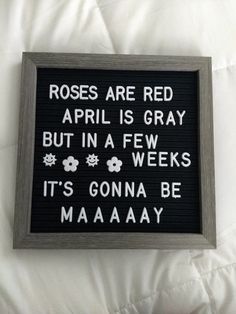 a sign that reads roses are red, april is gray but in a few weeks it's gone be maaaay