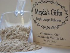 a bottle of mayonna oat next to a container of powdered sugar on a table