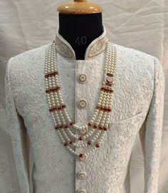 a mannequin with pearls and beads on it