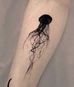 a black and white photo of a jellyfish tattoo