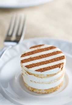 a white plate topped with a cake covered in frosting