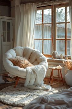 a white chair sitting in front of a window