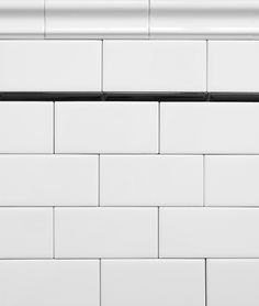 the corner of a white brick wall with black trim