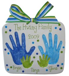 a ceramic ornament with two hands and the words, the having family 2009