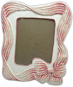 a white and red photo frame with a bow on the front, decorated in stripes