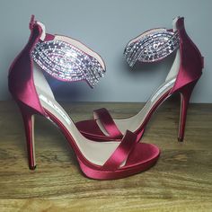 Gorgeous Ankle-Cuff Rhinestone Embellishment On Crimson Satin. Back Zip Entry. As Much As I Love These, I Tore My Acl In A 5k And Can No Longer Wear Heels. Now Someone Else Can Love Them! Brand New, Never Worn. Comes With Original Box. Maintained In A Pet-Free And Smoke-Free Home. -Heel Height: 5 Inches -Platform: 1/2 Inch -Satin Upper -Composition Leather Sole Holiday Embellished Ankle Strap Heels, Glamorous Red Sandals For Wedding, Elegant Red Heels With Rhinestones, Elegant Embellished Red Heels, Elegant Red Embellished Heels, Red Fitted Heels With Rhinestones, Fitted Red Heels With Rhinestones, Glamorous Red Embellished Sandals, Red Fitted Rhinestone Heels