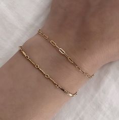 Elevate your everyday look with this timeless 14k Ella Bracelet. Featuring classic minimal design, it will add a little sparkle to any ensemble. 14K Gold Fill Chain and Components Length: 6.75" (option to add extender chain making bracelet 7.5") (If you want a custom length please email us at info@shopcdahl.com prior to or within 30 minutes after your order.) Other bracelet in the photo on the wrist is our Eze Bracelet Dainty Necklace Layered, Chain Making, Gold Link Bracelet, Minimal Chic, Custom Necklace, Gold Filled Chain, Bracelet Stack, Layered Necklaces, Link Bracelets