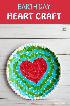 a paper plate with a heart on it and the words earth day heart craft above it