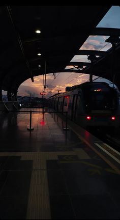 a train is coming down the tracks at dusk