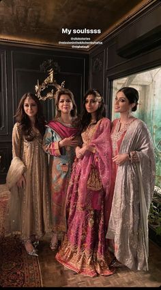 three women standing next to each other in dresses