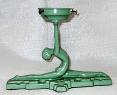 a green lamp sitting on top of a table