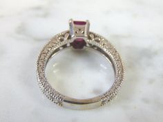 FOR SALE IS THIS LOVELY VINTAGE ESTATE 14K WHITE GOLD RING WITH AN EMERALD CUT GARNET STONE AND DIAMOND CHIPS. RING IS A SIZE 6.5 AND WEIGHS 4.9g. THERE ARE ABOUT .04cts OF DIAMONDS. THE GARNET IS ABOUT .75cts. THE RING MAKES A BEAUTIFUL GIFT FOR THAT SOMEONE SPECIAL. ANY OTHER QUESTIONS, PLEASE ASK. BE SURE TO CHECK OUT SOME OF MY OTHER GREAT ITEMS UP FOR SALE. THANK YOU Garnet And Diamond Ring, Yellow Gold Diamond Ring, Chalcedony Ring, Sapphire Diamond Ring, Garnet Stone, 14k White Gold Ring, White Gold Ring, Multi Stone Ring, Gold Diamond Rings