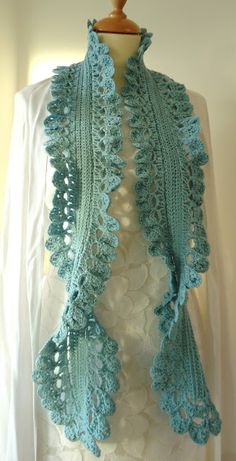 a blue crocheted shawl on a mannequin