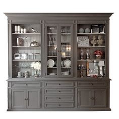 a large gray china cabinet with glass doors