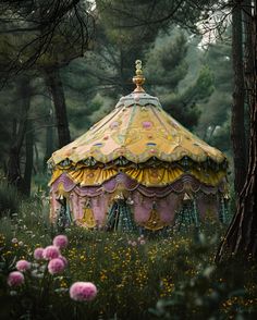 a colorfully painted carousel in the middle of a forest filled with wildflowers