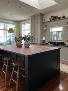 a large kitchen island with two stools in front of it