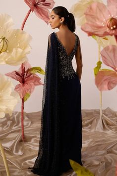 Navy blue draped gown with clematis moonlet bloom embroidery on the yoke using cutdana, sequin, crystals highlights, dangling cutdana strings and one sided mesh jaal drape embellished with crystals detailing. - Aza Fashions Pre-draped Evening Gown For Wedding, Draped Evening Dress With Sweep Train For Wedding, Pre-draped Floor-length Evening Gown, Evening Floor-length Pre-draped Gown, Wedding Evening Dress With Draped Sweep Train, Wedding Evening Dress With Draped Fitted Bodice, Festive Evening Dress With Sweep Train For Gala, Festive Evening Gown With Traditional Drape, Festive Evening Gown With Sweep Train