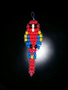 an ornament made out of beads on a black surface