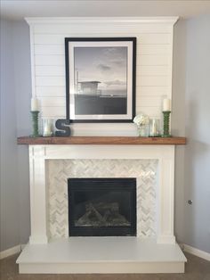 a white fireplace with some candles on it