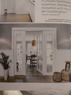 an open door leading to a kitchen and dining room with white walls, flooring and furniture