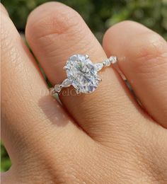 a woman's hand with a diamond ring on it