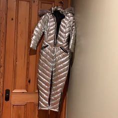 Puffer Insulated Ski Bunny Suit. All In One With Gorgeous Sinch Belt. Detachable Faux Fur Hood. Brand New Without Tags. (I Am 5’9 162# With 38c Bust 31waist 40hips.) It’s To Tight On Me & Sleeves Ran Short On My Wrists. Exact Size Unknown Bc No Tag Luxury Silver Outerwear For Winter, Luxury Silver Outerwear For Parties, Glamorous Fitted Silver Outerwear, Luxury Fitted Silver Outerwear, Silver Evening Outerwear For Winter, Elegant Fitted Metallic Outerwear, Silver Winter Outerwear For Formal Occasions, Silver Formal Outerwear For Winter, Formal Fitted Silver Outerwear