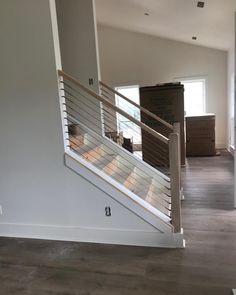 an empty room with stairs and boxes on the floor