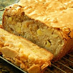 a loaf of banana bread sitting on top of a cooling rack next to another loaf