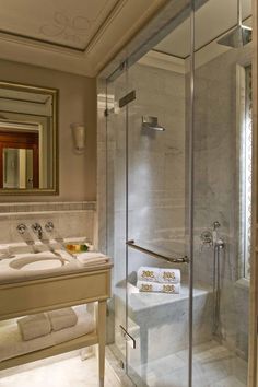 a bathroom with two sinks and a bathtub next to a walk - in shower