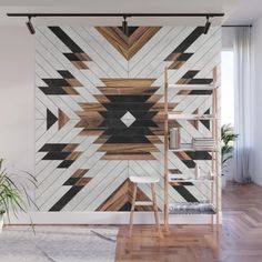 an artistic wall mural in a living room with wood flooring and white walls, along with a wooden ladder