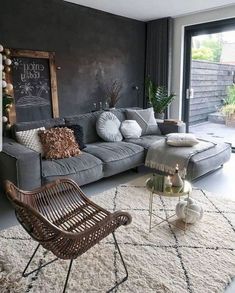 a living room filled with furniture and a chalkboard on the wall