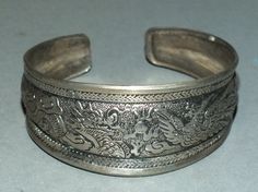 This metal bracelet with the Buddhist auspicious symbols originates from Thailand. The inner diameter is 6.2 cm. It is 2.9 cm wide and 0.2 cm thick. (you can bend it to widen) Its weight is 30 gram. (e15).1 SHIPPING SHIPMENT is FREE. All items are shipped within two working days after receipt of payment. We send everything by registered airmail. Insured packets (over 50 cm length / over 1500 gram) I send by standard way. PAYMENT Paypal is preferred. RETURN POLICY: NO RISK: Any item may be sent b Spiritual Metal Bracelet For Festivals, Spiritual Metal Bracelets For Festivals, Symbolic Round Cuff Bracelet Gift, Symbolic Bangle Bracelets For Festivals, Symbolic Festival Bangle Bracelet, Symbolic Ceremonial Bangle For Festivals, Antique Silver Adjustable Bracelet For Ceremonial Occasions, Adjustable Antique Silver Bracelet For Ceremonial Occasions, Adjustable Symbolic Bracelets For Ceremonial Occasions