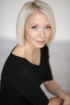 a woman with blonde hair posing for a photo