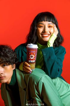 a woman sitting next to a man holding a coffee cup