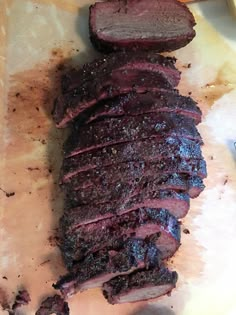 sliced up meat sitting on top of a cutting board