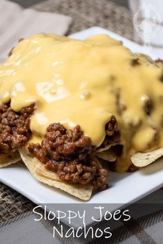 sloppy joe's nachos on a white plate topped with ground beef and cheese