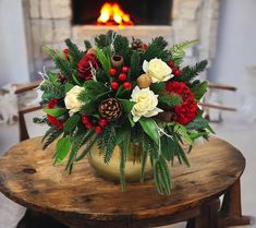 a vase filled with flowers sitting on top of a table next to a fire place